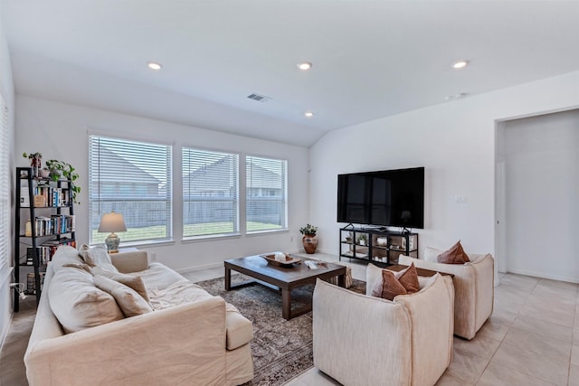 living room with light tile patterned floors, recessed lighting, visible vents, vaulted ceiling, and baseboards