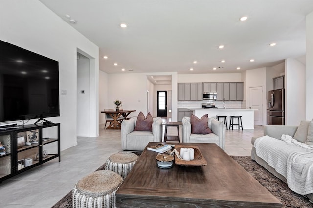 living area with light tile patterned floors, baseboards, and recessed lighting