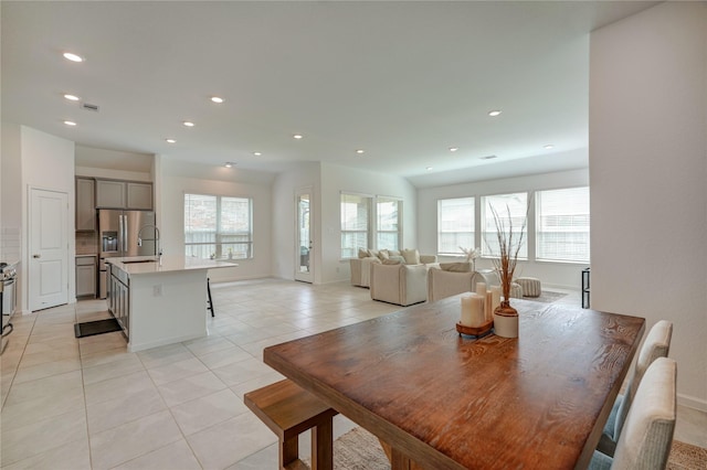 dining area with recessed lighting, plenty of natural light, and light tile patterned floors