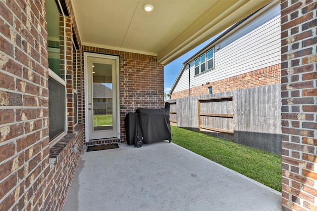 view of patio with fence and area for grilling