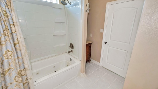 full bath featuring a combined bath / shower with jetted tub, baseboards, and tile patterned floors