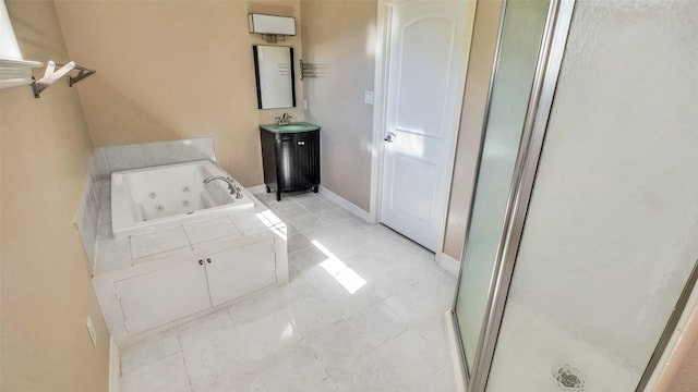 full bath featuring a sink, baseboards, tile patterned floors, a whirlpool tub, and a stall shower