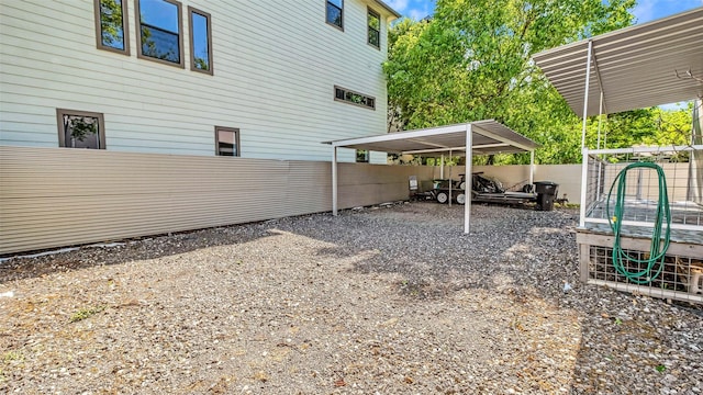 view of vehicle parking with a carport and fence