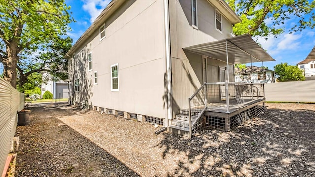 view of side of property featuring crawl space and fence