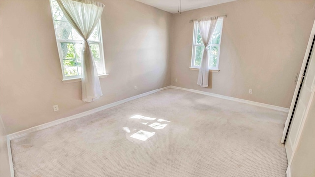 carpeted spare room with baseboards