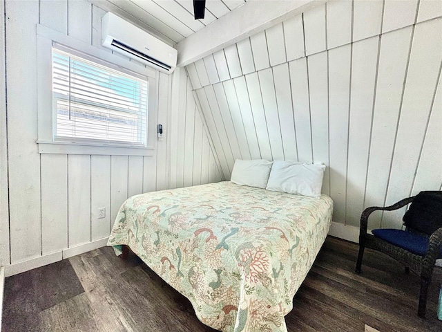 310 Angel Wing St, Surfside Beach, TX 77541 - bedroom with dark wood-style floors, lofted ceiling with beams, wood walls, a wall mounted air conditioner, and baseboards