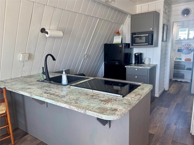 310 Angel Wing St, Surfside Beach, TX 77541 - kitchen with cooktop, freestanding refrigerator, built in microwave, gray cabinets, and a sink