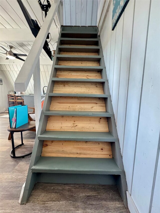 310 Angel Wing St, Surfside Beach, TX 77541 - stairway with ceiling fan, wooden walls, and wood finished floors
