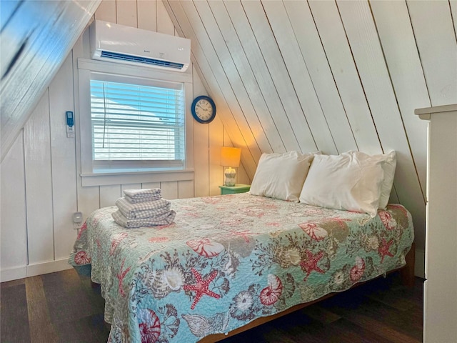 310 Angel Wing St, Surfside Beach, TX 77541 - bedroom with lofted ceiling, wooden walls, wood finished floors, and a wall mounted AC