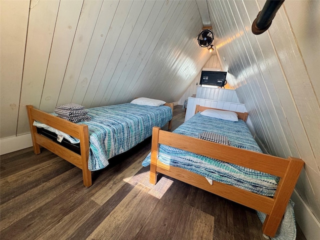 310 Angel Wing St, Surfside Beach, TX 77541 - bedroom with wood walls, vaulted ceiling, and wood finished floors