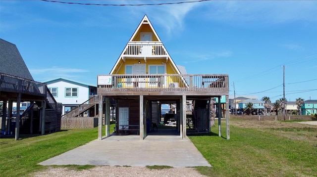 view of front of house featuring stairs, a carport, and a front lawn