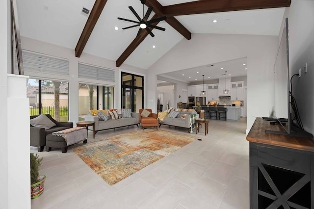 living room featuring ceiling fan, high vaulted ceiling, light tile patterned flooring, visible vents, and beam ceiling