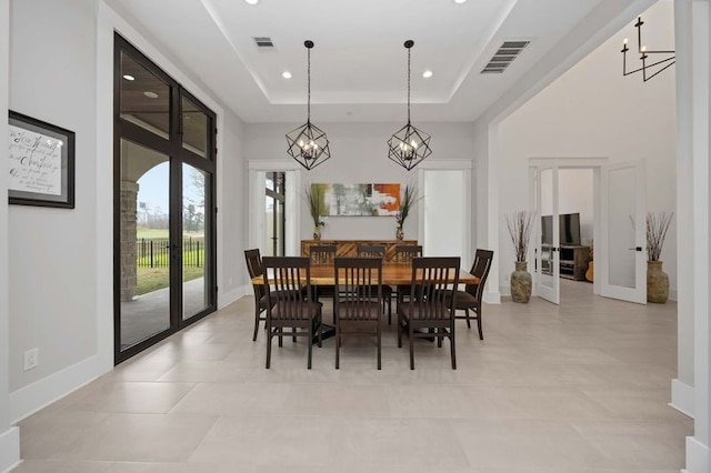 dining space featuring recessed lighting, visible vents, a tray ceiling, and french doors