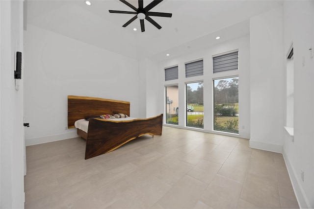 bedroom featuring a high ceiling, baseboards, a ceiling fan, and recessed lighting