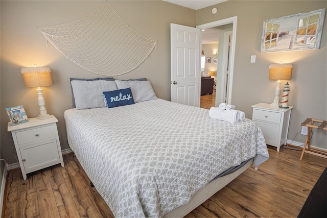 bedroom featuring wood finished floors and baseboards