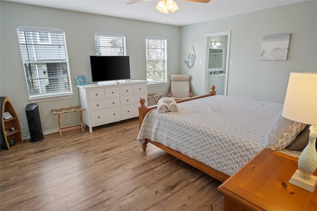 bedroom featuring light wood-style flooring, baseboards, and ceiling fan