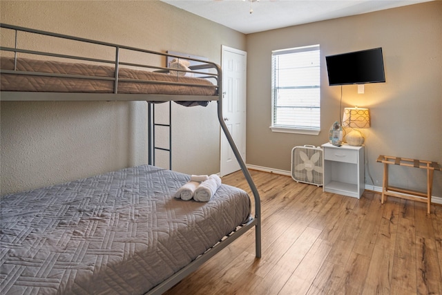 bedroom featuring wood-type flooring and baseboards
