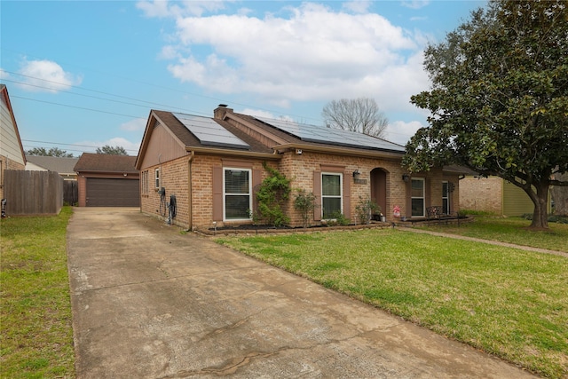 single story home featuring an outbuilding, a garage, brick siding, fence, and a front lawn