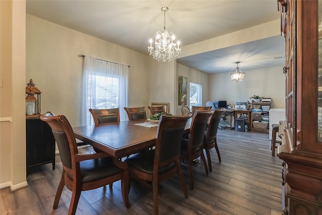 dining room featuring baseboards, dark wood finished floors, and an inviting chandelier