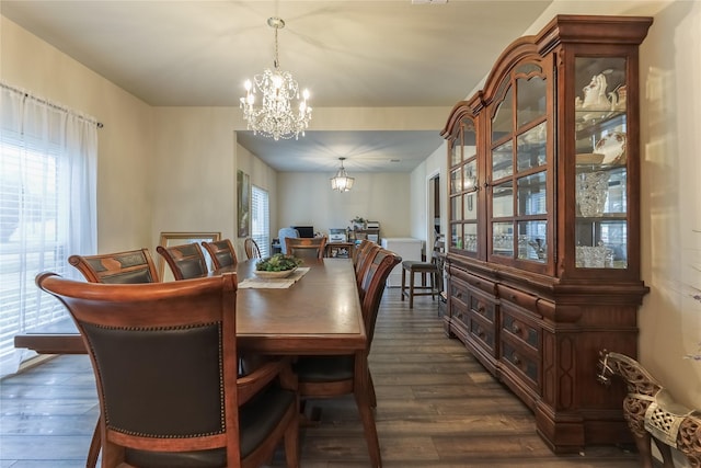 dining space featuring a chandelier and dark wood finished floors