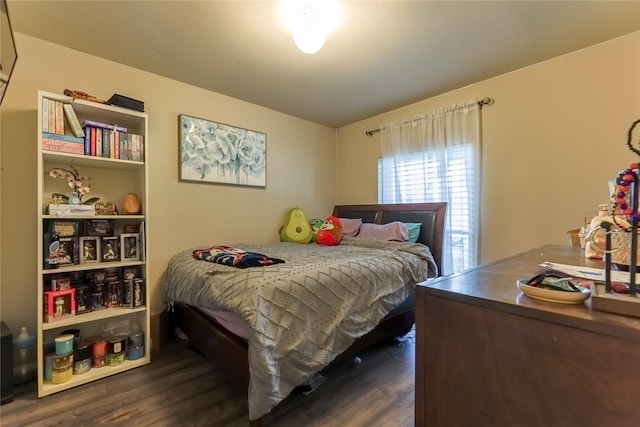 bedroom with dark wood-style flooring