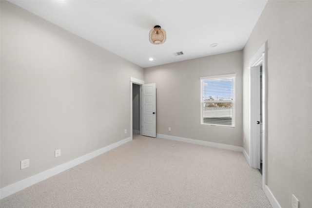 unfurnished bedroom featuring recessed lighting, visible vents, light carpet, and baseboards