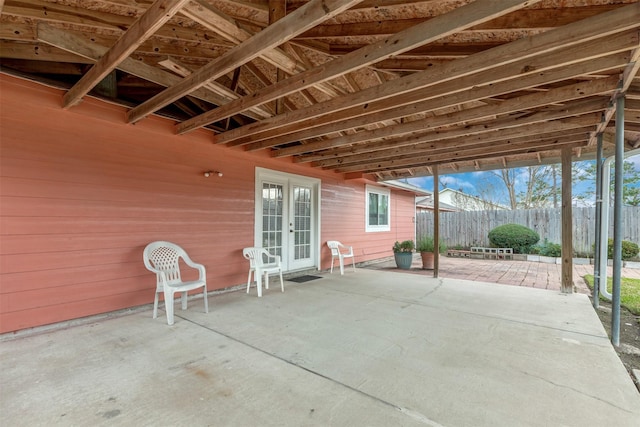 view of patio / terrace featuring french doors and fence