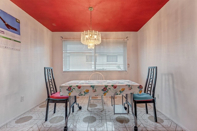 dining area with an inviting chandelier