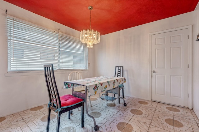 dining room featuring tile patterned flooring and a chandelier