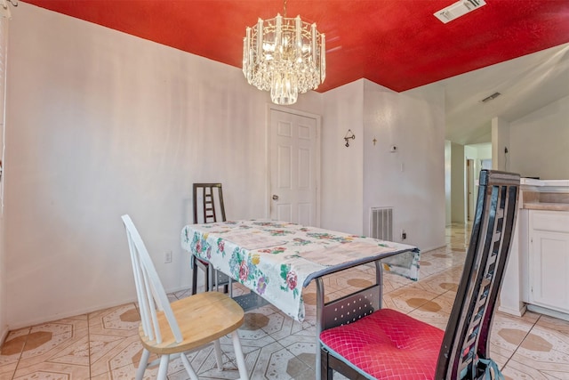 dining space with light tile patterned floors, visible vents, and a notable chandelier