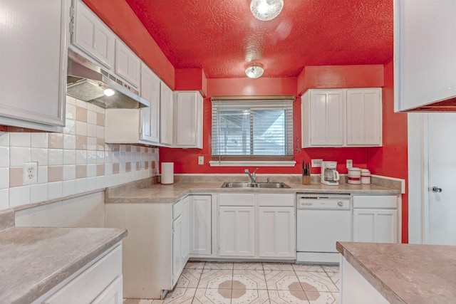 kitchen with white dishwasher, white cabinetry, light countertops, and a sink