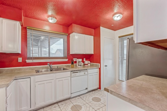 kitchen featuring white cabinets, white dishwasher, and a sink