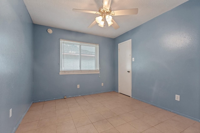 unfurnished room featuring a textured ceiling and a ceiling fan