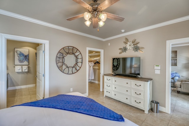 bedroom featuring light tile patterned floors, baseboards, ceiling fan, a walk in closet, and crown molding