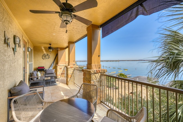 balcony featuring a water view and a sunroom