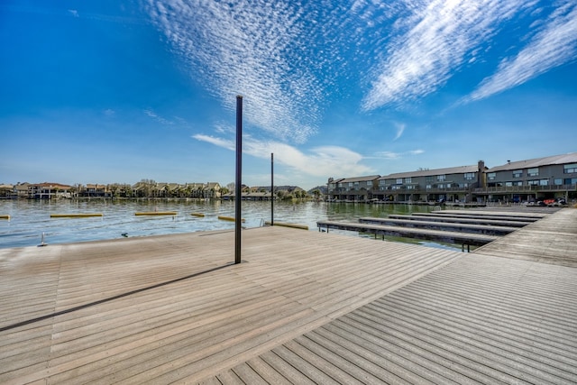 view of dock featuring a residential view and a water view