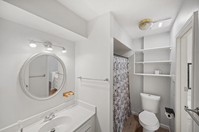 bathroom with toilet, a shower with curtain, wood finished floors, and vanity