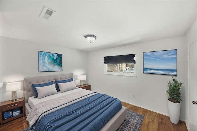 bedroom with visible vents and wood finished floors