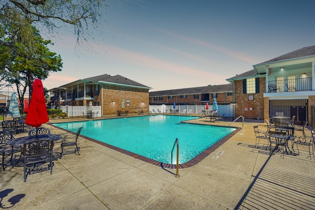 pool with fence and a patio