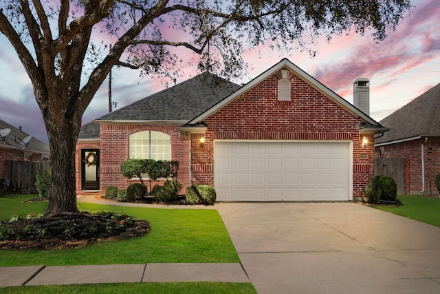 single story home with brick siding, an attached garage, and fence