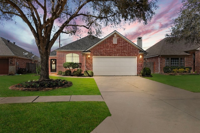 view of front of property featuring a garage, a yard, brick siding, and driveway