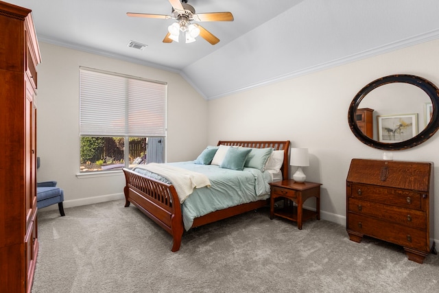 carpeted bedroom featuring visible vents, baseboards, lofted ceiling, and ornamental molding