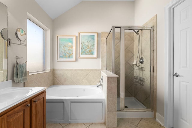 full bathroom with a garden tub, a shower stall, tile patterned flooring, lofted ceiling, and vanity