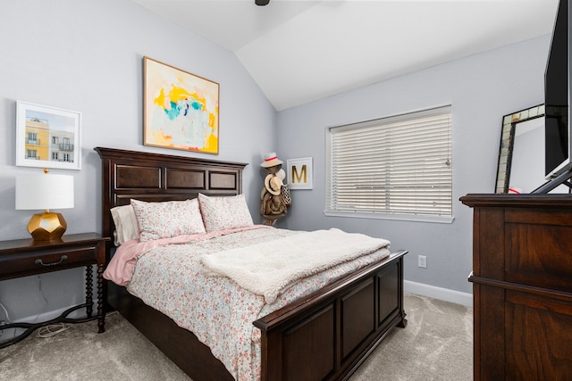 bedroom featuring lofted ceiling, baseboards, and light carpet