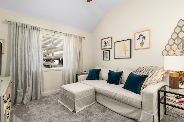 carpeted living room featuring baseboards and lofted ceiling