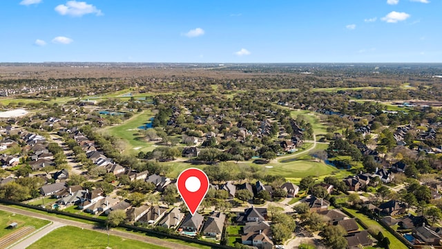 birds eye view of property with view of golf course and a residential view