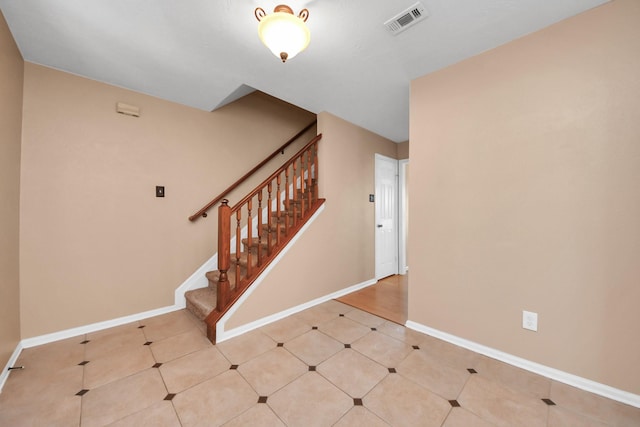 interior space featuring stairway, visible vents, and baseboards