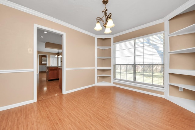 unfurnished dining area with baseboards, built in features, light wood-style flooring, and an inviting chandelier