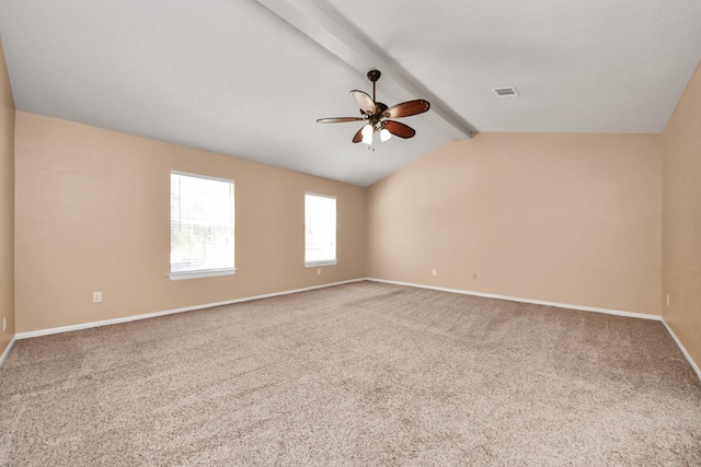 empty room with carpet, vaulted ceiling with beams, visible vents, ceiling fan, and baseboards