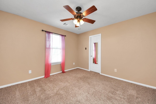 unfurnished room featuring visible vents, ceiling fan, light carpet, and baseboards